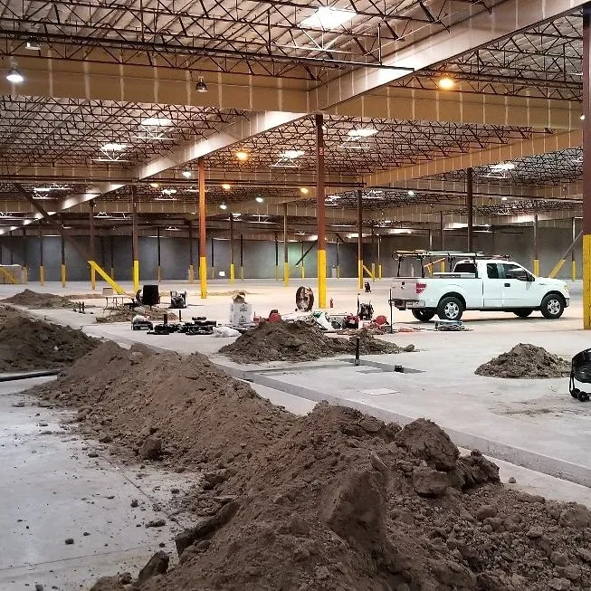 Commercial plumbing work underway inside a large Los Angeles warehouse